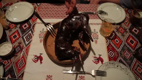 Roasted whole rabbit on the dinner table cut by hand Stock Footage 253785944