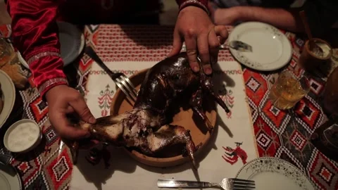 Roasted whole rabbit on the dinner table cut by hand Stock Footage 253786120