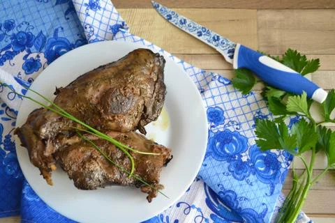 Roasted wild rabbit or hare legs, hunting russian cuisine, traditional gzhel Stock Photos