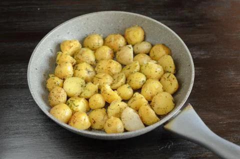 Roasted young potatoes in a pan Stock Photos
