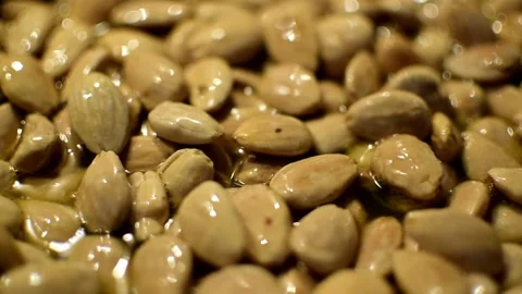Roasting almonds in a pan. Close-up view of roasted almond Video stock 144776612