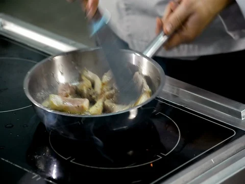 Roasting and cooking meat in a frying pan Stock Footage 71120110