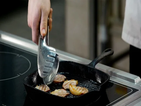 Roasting and cooking meat in a frying pan Stock Footage 71132863