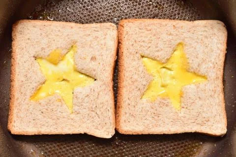 Roasting bread toasts with a star-shaped middle and omelette filled with egg  Stock-Fotos