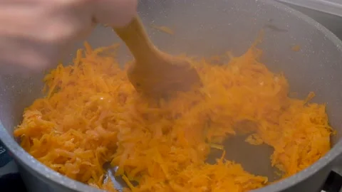 Roasting carrots in a pan Stock Footage 222907418