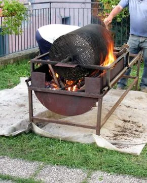 Roasting chestnuts in barbeque Stock Photos