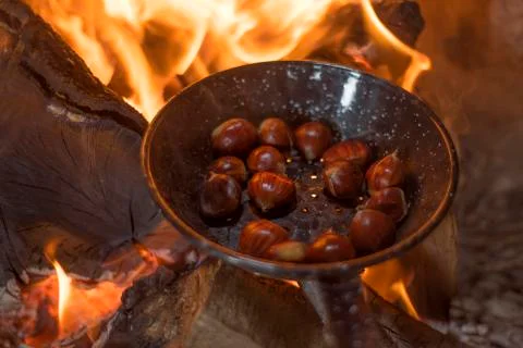 Roasting chestnuts on fire in a pan 스톡 사진