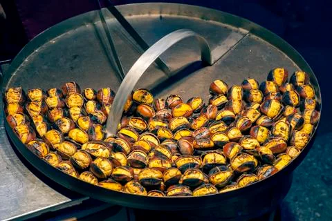Roasting chestnuts at streets 2 Stock Photos
