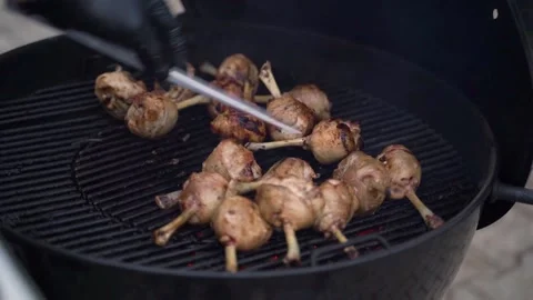 Roasting chicken legs on a grill Video stock 218612543