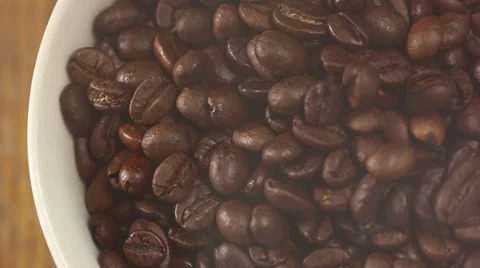 Roasting coffee beans intersperse into a pile close-up Stock Footage 56708955