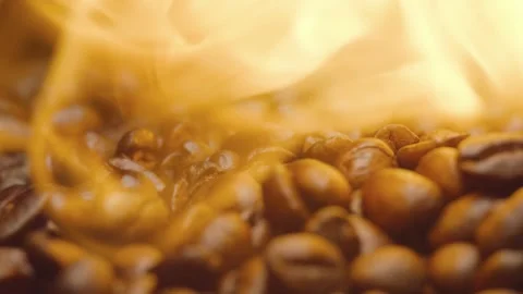 Roasting coffee beans in rotation. Circular filming of coffee beans on fire. Stock Footage 303634754