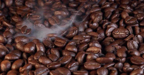 Roasting coffee beans with smoke on dark background, close up arabica robusta 스톡 동영상 235927952