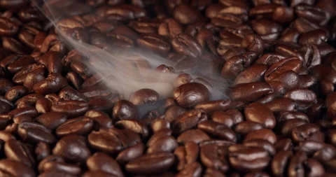 Roasting coffee beans with smoke on dark background, close up arabica robusta Stock Footage 236227455