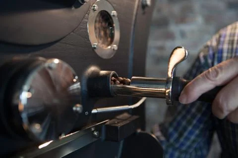 Roasting of coffee beans - verifying process Stock Photos