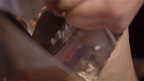 Roasting coffee .Coffee pours through the chute in a paper bag from the VAT Video stock 99750281
