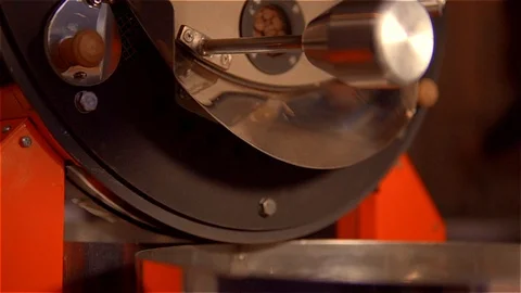 Roasting coffee .Coffee pours through the gutter into the tank for cooking Video stock 99750545