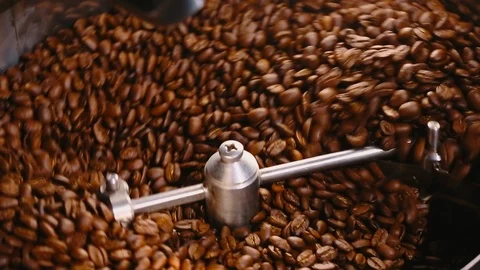 Roasting coffee. Coffee roasting machine. Close-up. Video stock 100755298