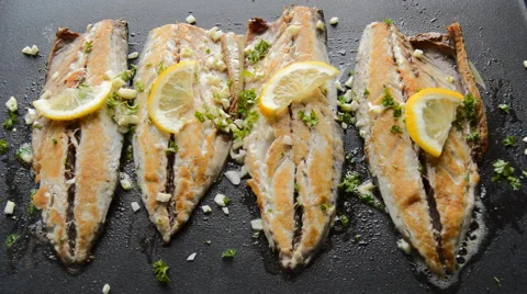 Roasting Fish on a Pan with Condiments and Lemon Stock Footage 46857694