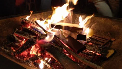 Roasting marshmallow around a firepit in the backyard with friends Stock Footage 127633309
