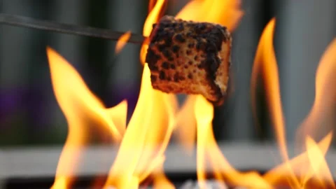 Roasting marshmallows in flames marshmallow on fire in slow motion close up Stock Footage 205164952