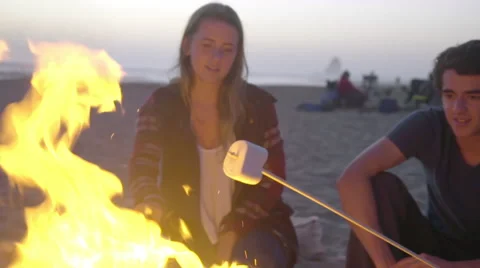 Roasting marshmallows over the fire Stock Footage 53257345