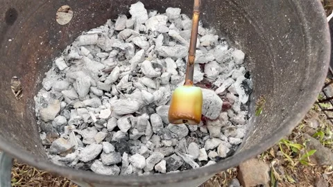 Roasting marshmallows on a stick over a BBQ. Stock Footage 332231905