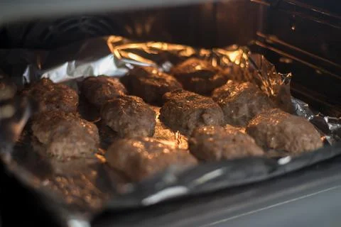 Roasting meat cutlets in the oven. Stock Photos