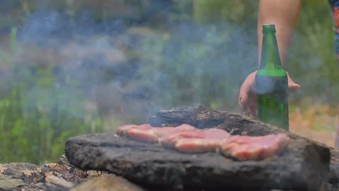 Roasting meat on a stone of fire Stock Footage 113274933
