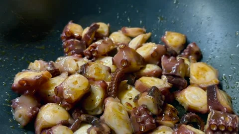 Roasting of octopus slices in the pan Stock Footage 266540139
