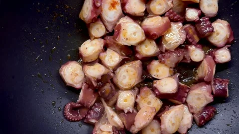 Roasting of octopus slices in the pan Stock Footage 266540150