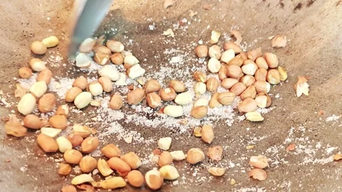 Roasting peanuts with salt in a metal pan close-up. Stock Footage 342401626
