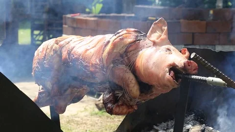 Roasting piglet , grilled pig at street food market , Thailand Stock Footage