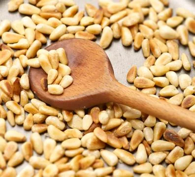 Roasting pine nuts in a pan Stock Photos