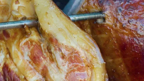 Roasting Pork Knuckle on Spit Over Open Wood Fire Stock Footage 323341529
