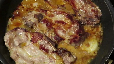 Roasting pork steak in pan with spices like mustard and pepper Stockbeeldmateriaal 116889870