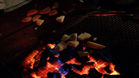 Roasting potatoes at night time 動画素材 169805326