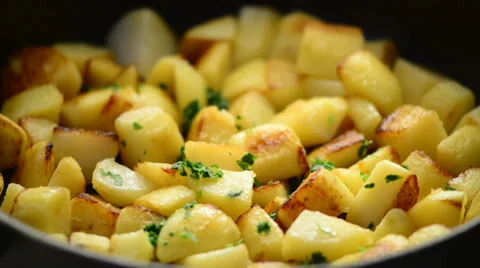 Roasting potatoes in a pan close up shoot Stock Footage 39593306