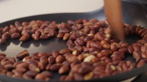 Roasting Raw Coffee Beans in an Expert and Skilled Process to Create Unique Stock Footage 306063967