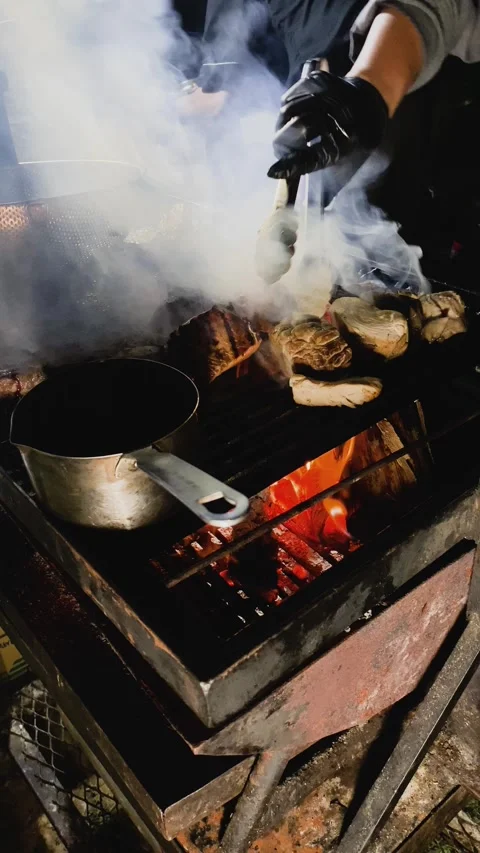 Roasting raw meat steak on burning fire. Stock Footage 288797766