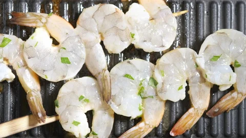 Roasting raw shrimp on a grill pan Stock Footage 101353606