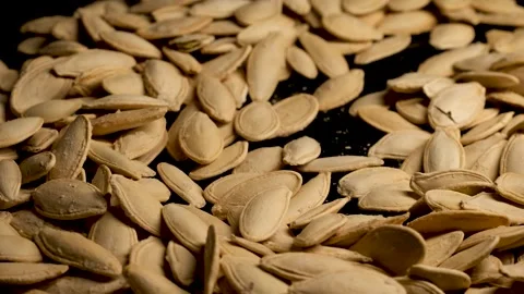Roasting Salted Pumpkin Seeds Close Up Stock Footage 329968266