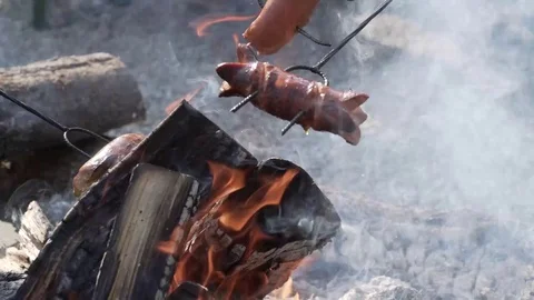 Roasting of Sausages on open fire Stock Footage 75079595