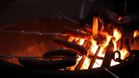 Roasting sausages over a fire Stock Footage 90822379
