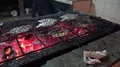 Roasting seafood over coconut shell Jimbaran beach restaurant Bali - Indonesia 4k or 4k+ Resolution