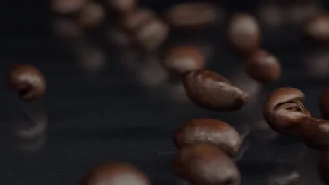 Roasting. Slow motion shot of fresh roasted brown coffee beans rolling, falling 스톡 동영상 150559897