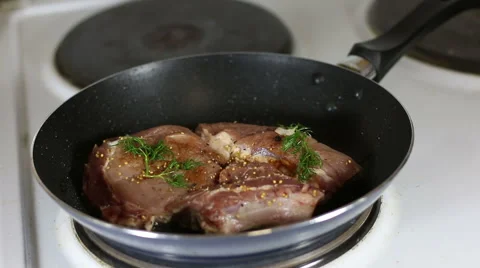 Roasting the steak in a pan Stock Footage 66359446
