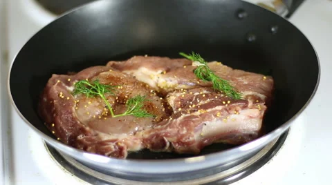Roasting the steak in a pan Stock Footage 66361376