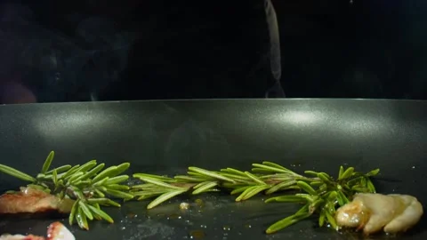 Roasting steaks on frying pan at kitchen, closeup view of cooking process. Shot Stock Footage 137318170