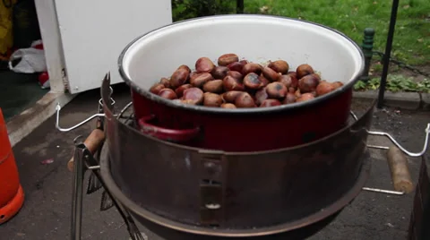 Roasting sweet chestnuts, cooked nuts, street vendor, hot food Stock Footage 37124225