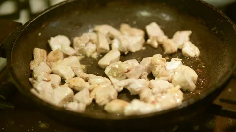 Roasts chicken meat in a frying pan for cooking Stock-Footage 103567945
